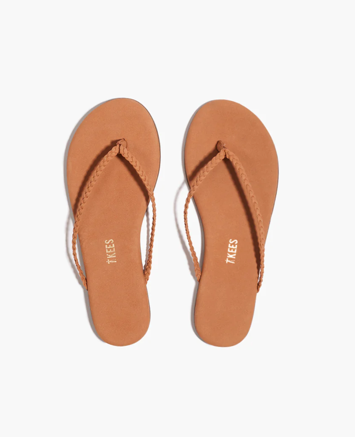 Pair of tan flip-flops with 'Tkees' branding on a white background