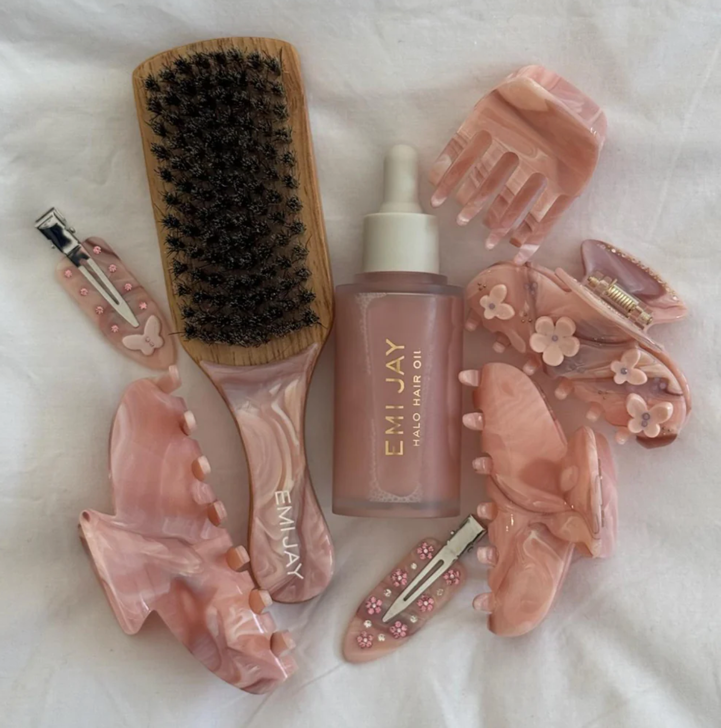 pink chantilly clip laid out among other Emi Jay products