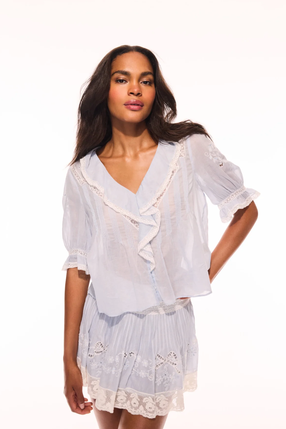 Woman wearing a white lace outfit on a white background