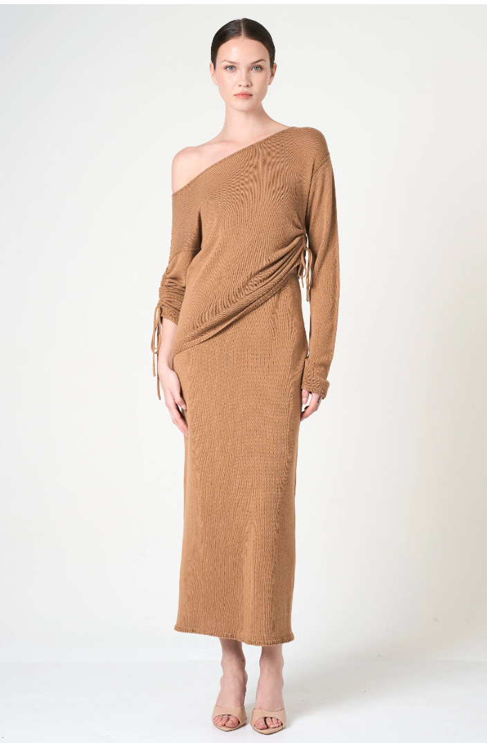 Woman wearing a brown off-shoulder dress on a white background