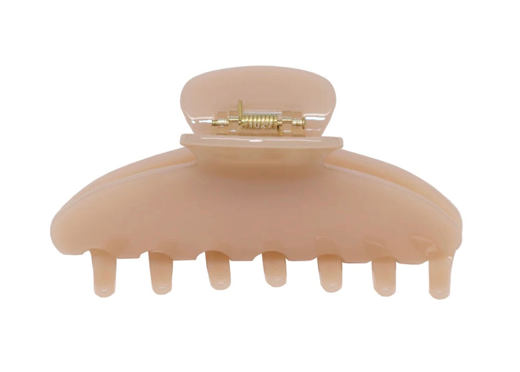 Tan claw clip on a white background