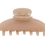Tan claw clip on a white background