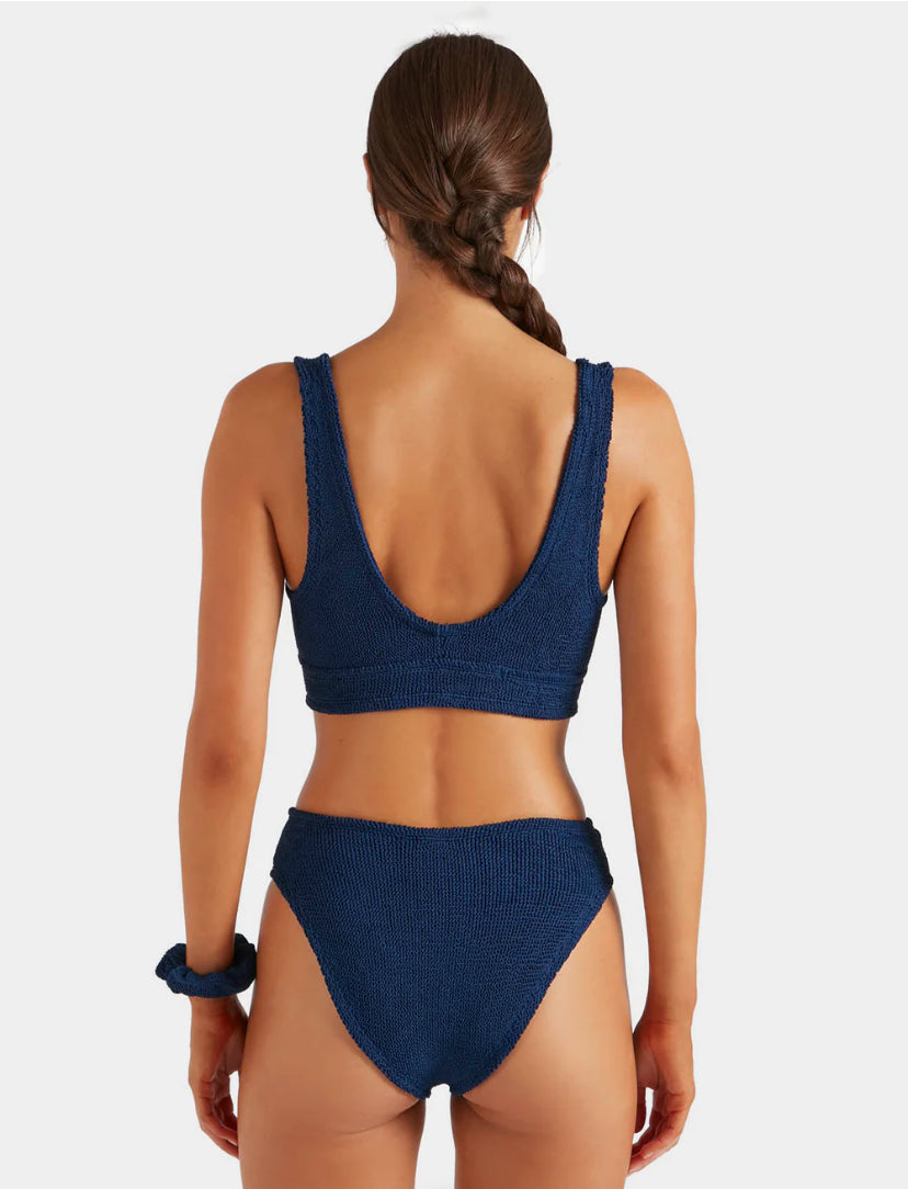 Woman wearing a blue bikini on a white background
