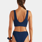 Woman wearing a blue bikini on a white background