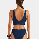 Woman wearing a blue bikini on a white background