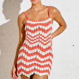 Woman wearing a red and white striped dress against a plain background
