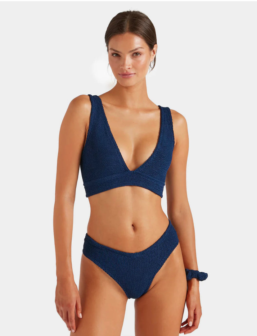 Woman wearing a blue bikini set on a white background