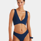 Woman wearing a blue bikini set on a white background