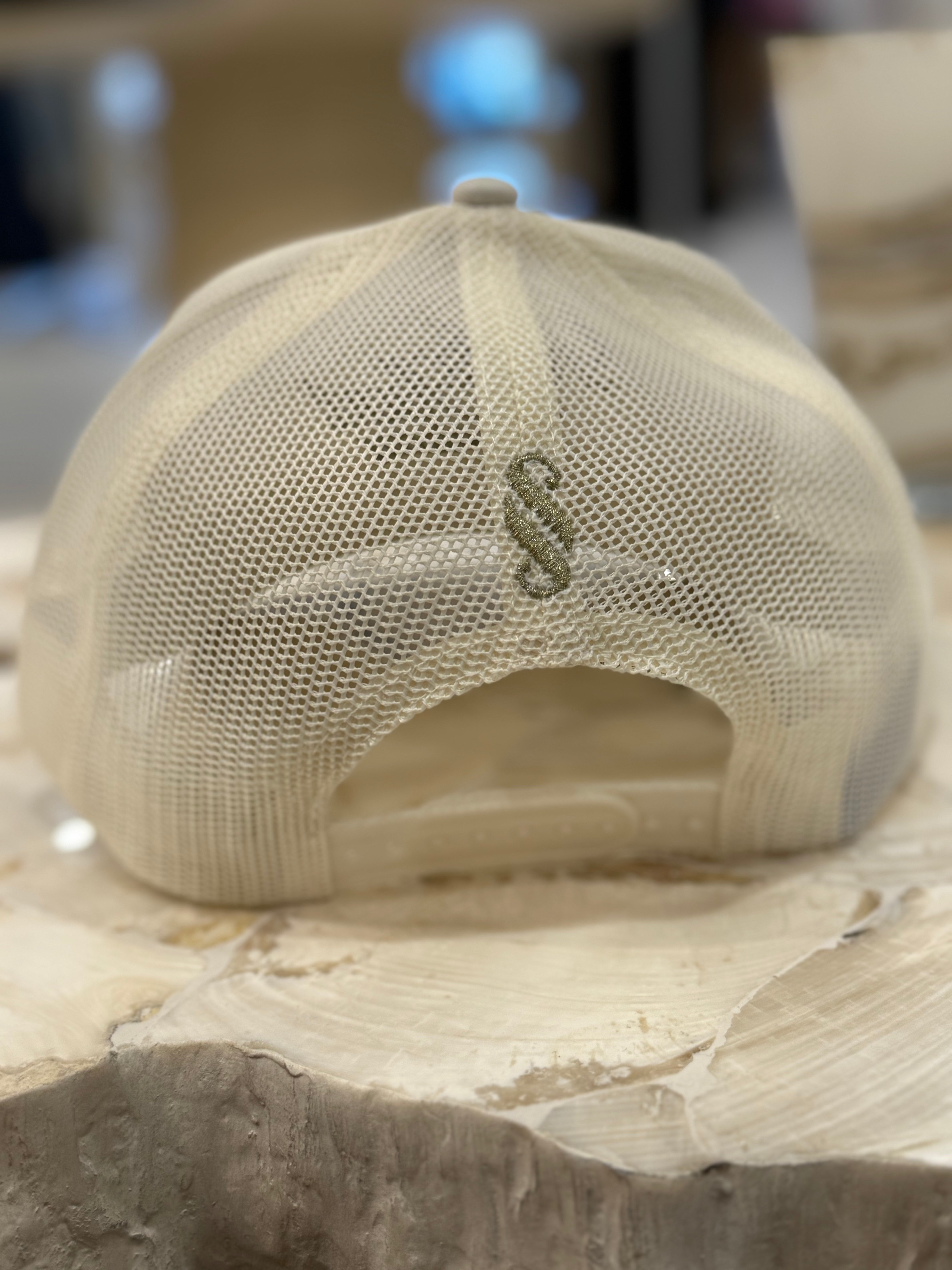 Beige mesh cap on a stone surface with a blurred background
