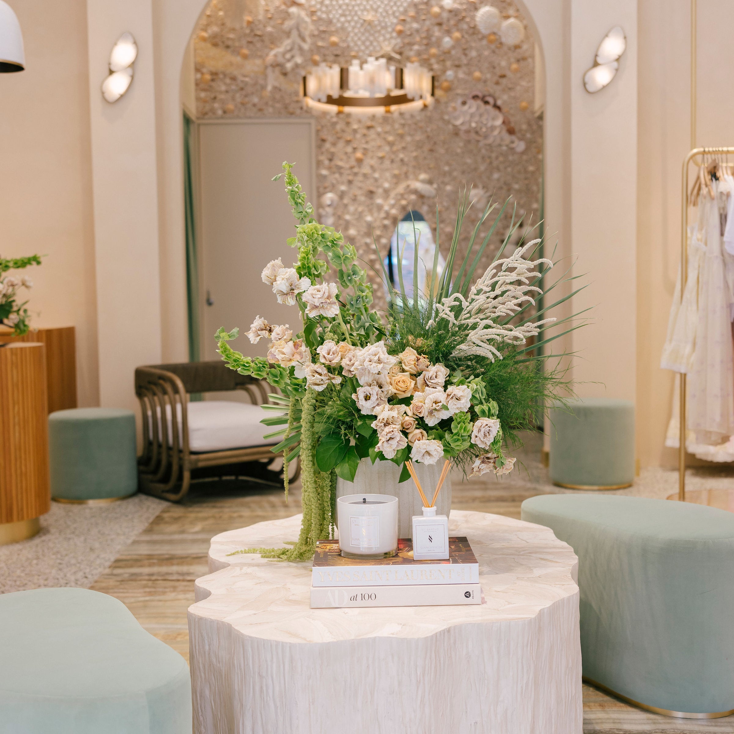 Decorative setup with flowers and candles on a table in a stylish interior setting.