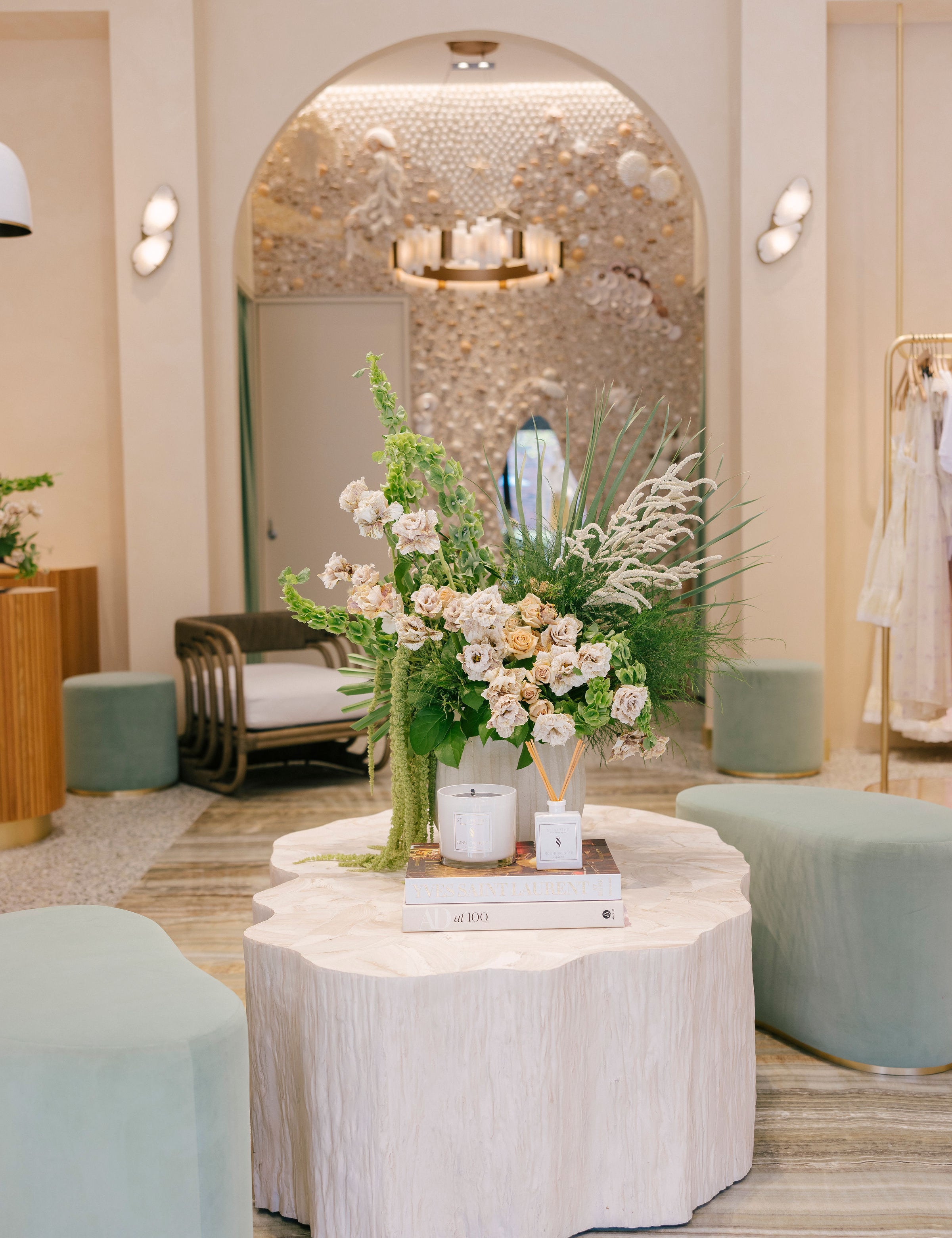 Decorative setup with flowers and candles on a table in a stylish interior setting.