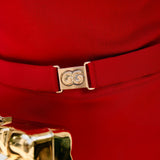 Close-up of a red knit garment with a gold belt and gold buttons.