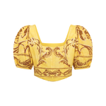 Yellow top with intricate pattern on a white background