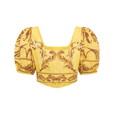 Yellow top with intricate pattern on a white background