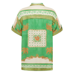 Green blouse with floral patterns on a white background