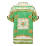 Green blouse with floral patterns on a white background