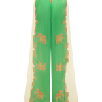 Green and beige pants with floral patterns on a white background