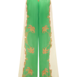Green and beige pants with floral patterns on a white background