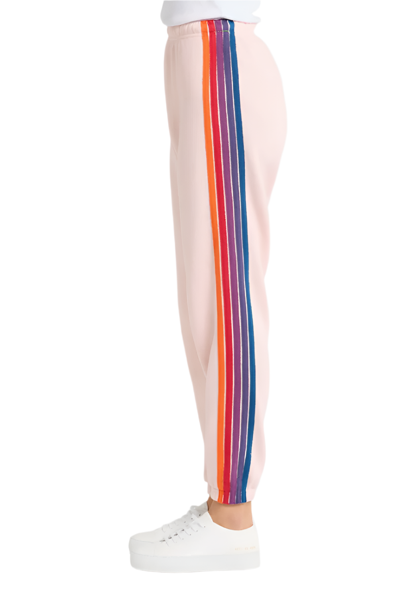 side view of light pink sweatpants with orange red purple and blue stripe on one side