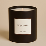 Black candle with a white label on a beige background
