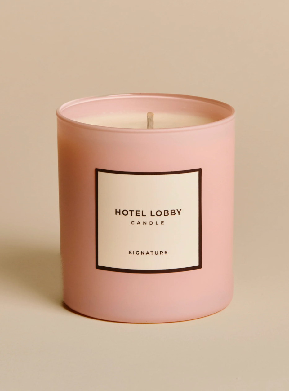 Pink candle with 'Hotel Lobby' label on a beige background