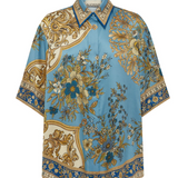 Decorative blouse with floral and baroque patterns on a white background