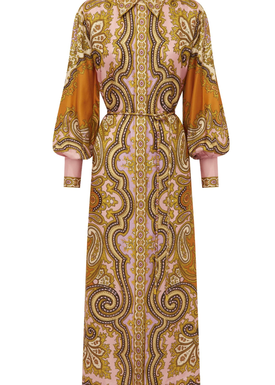 Long patterned dress with orange and gold accents on a white background