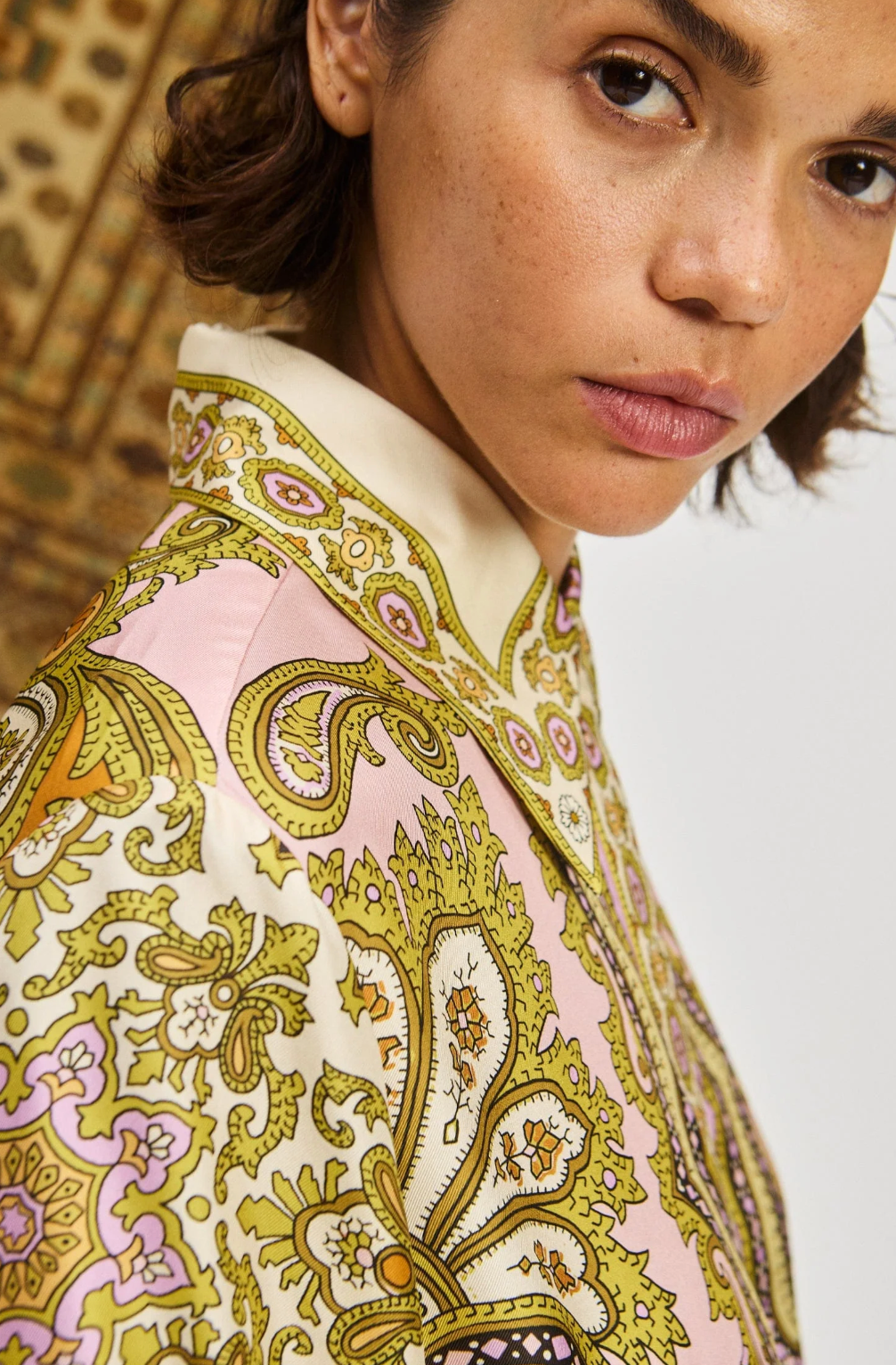 Close-up of a person wearing a patterned garment with intricate designs.