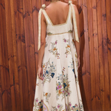 Woman wearing a floral dress with a wooden wall background
