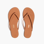 Pair of tan flip-flops with 'Tkees' branding on a white background