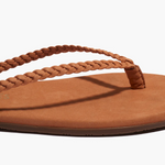 Brown sandal with braided strap on a white background