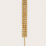 Gold chain necklace on a beige background