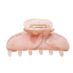 Pink hair clip with gold interior on a white background