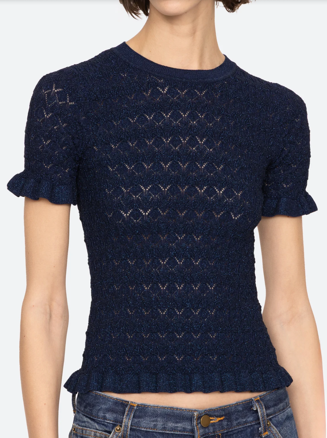 Navy blue patterned sweater worn by a person on a white background.