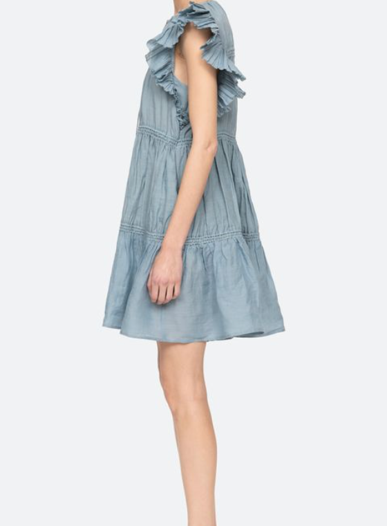 Light blue dress with ruffled details on a white background