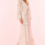 Woman wearing a lace dress on a pink background