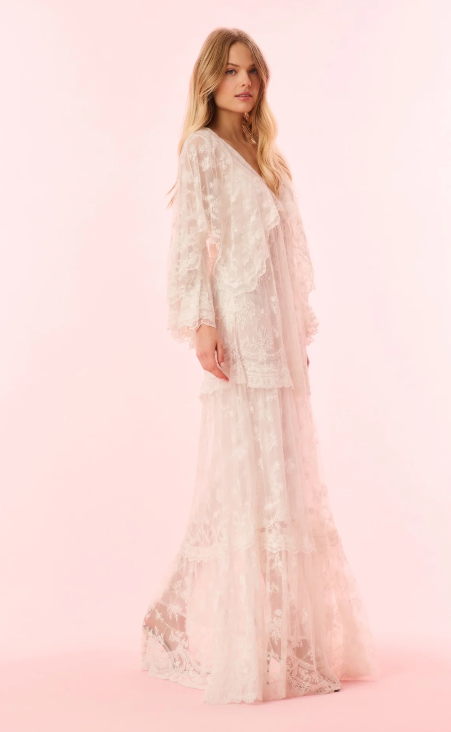 Woman wearing a lace dress on a pink background