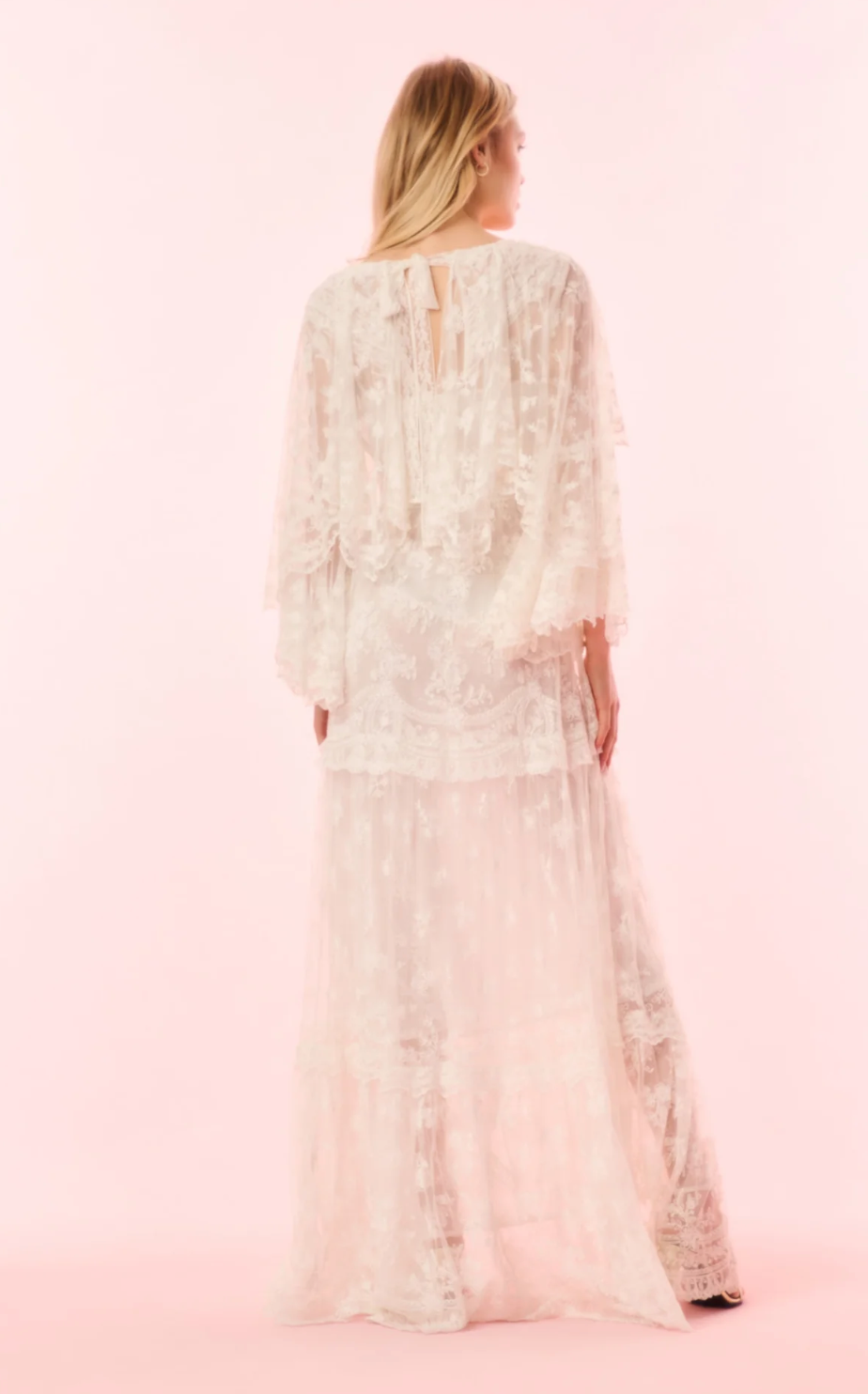 Woman wearing a floral dress on a pink background