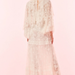 Woman wearing a floral dress on a pink background