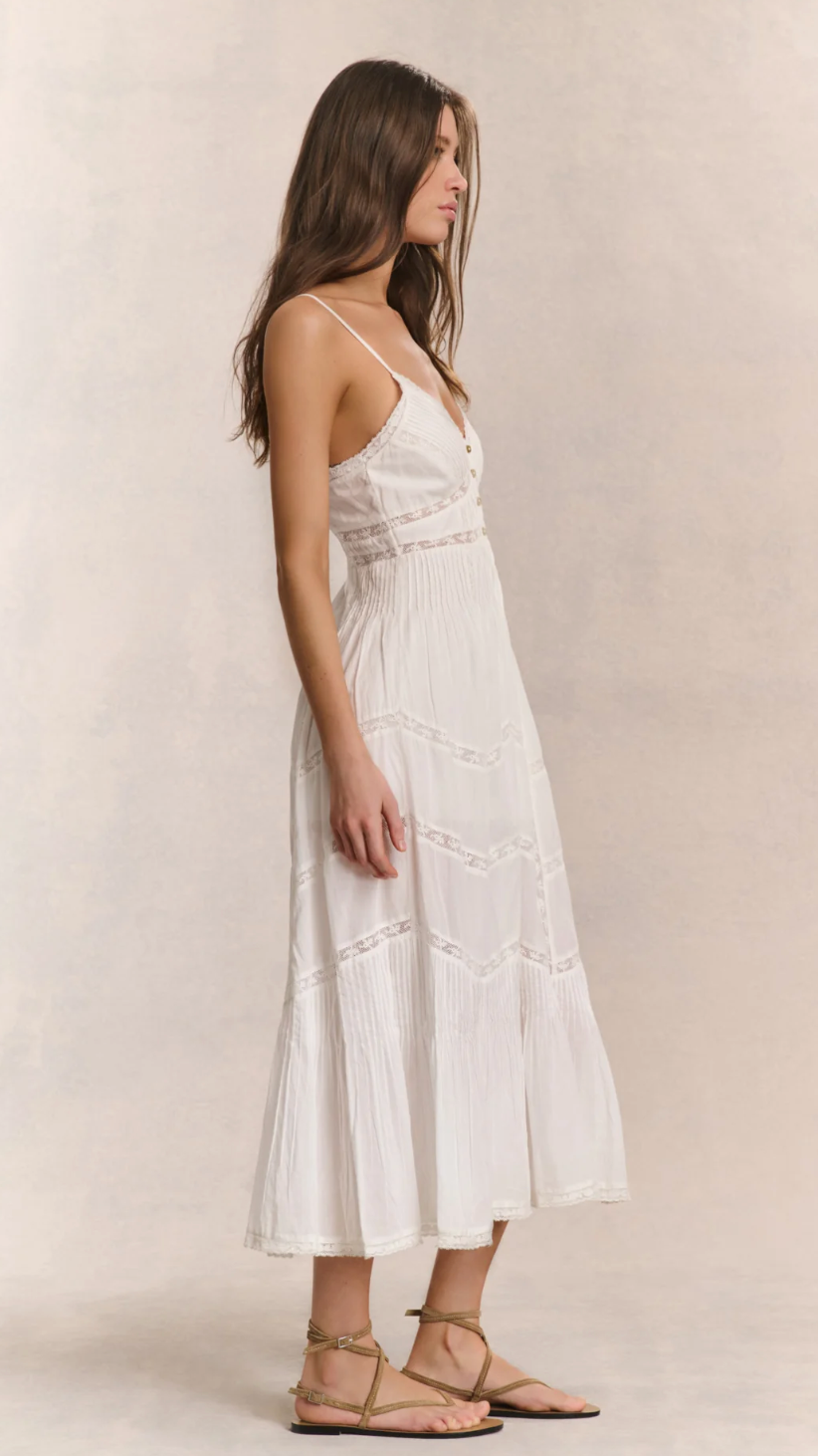 Woman wearing a white dress against a plain background