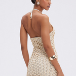 Woman wearing a beige crochet dress on a white background