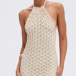 Woman wearing a beige crochet dress on a white background