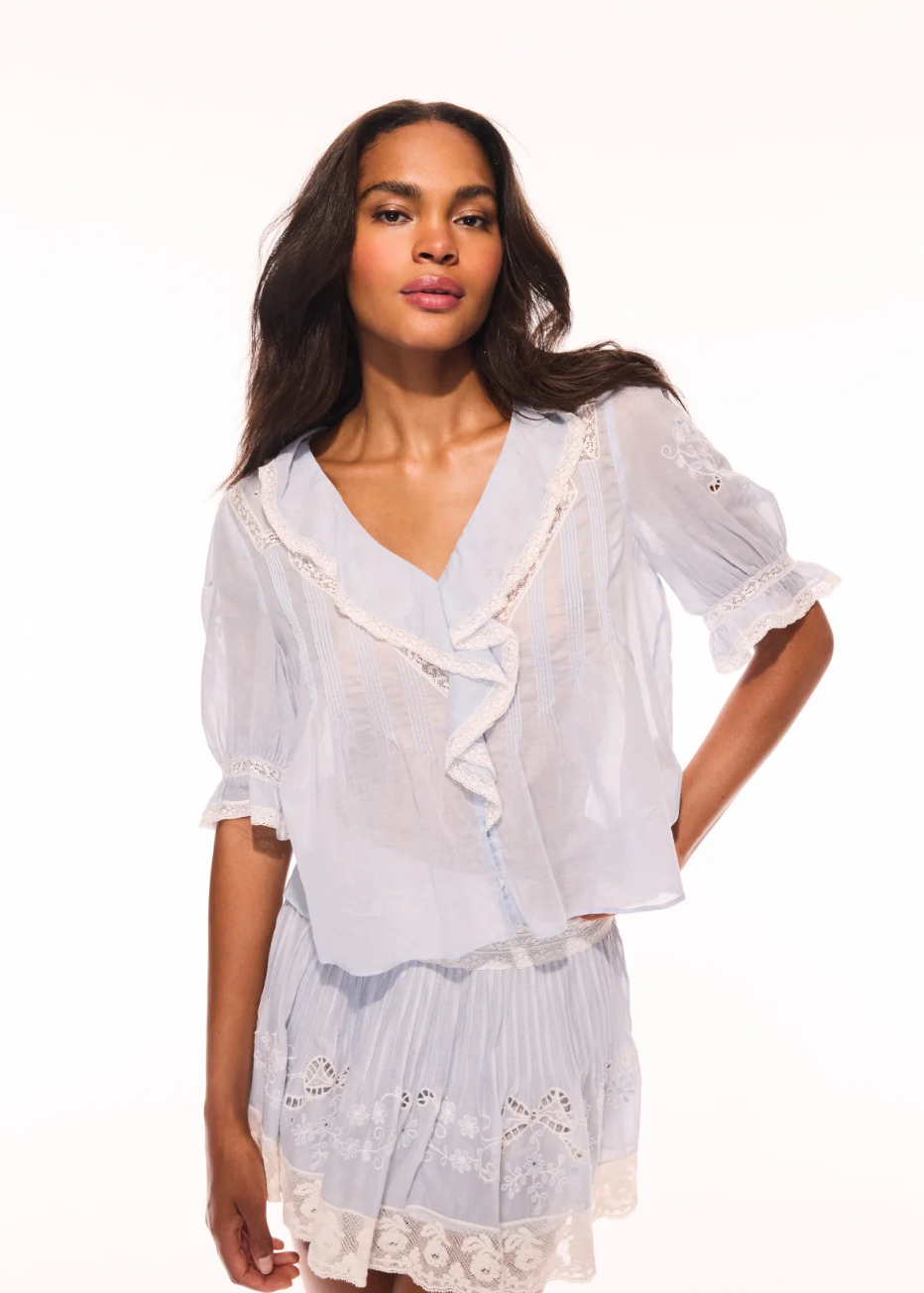 Woman wearing a white lace outfit on a white background