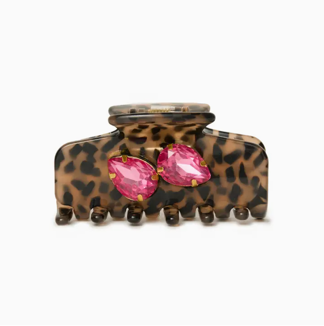 Leopard print hair clip with pink gemstones on a white background