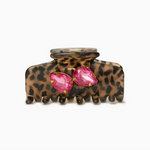 Leopard print hair clip with pink gemstones on a white background