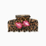 Leopard print hair clip with pink gemstones on a white background