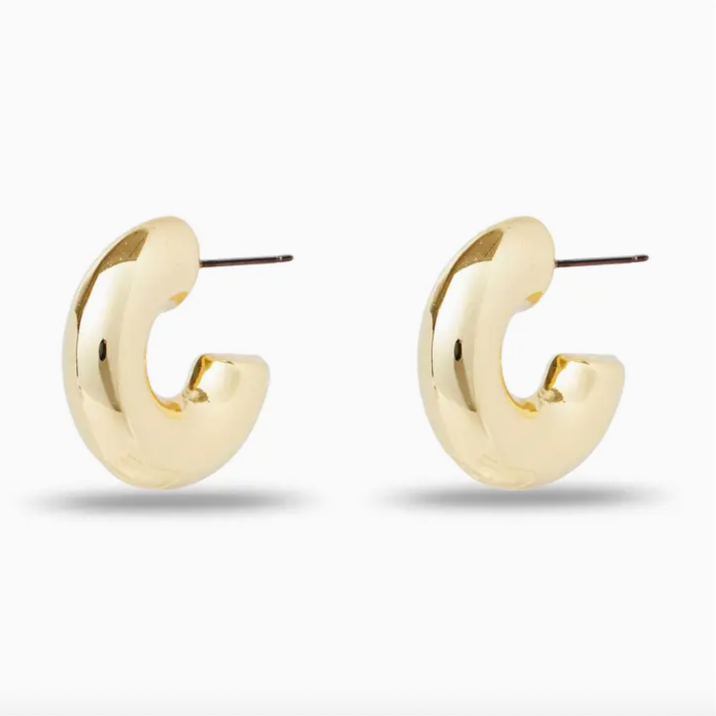 Chunky gold hoop earrings on a white background
