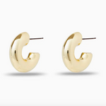 Chunky gold hoop earrings on a white background