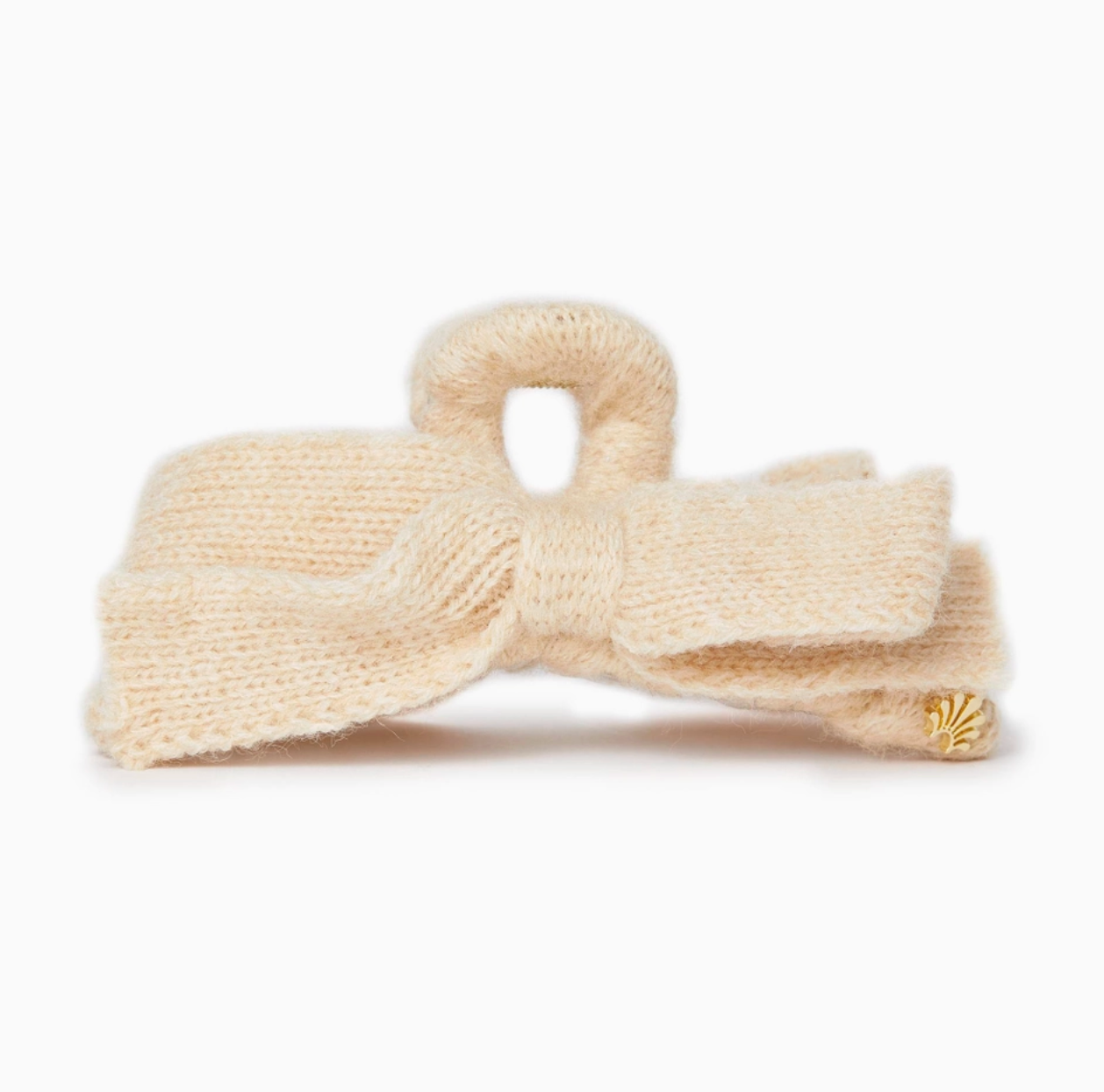 Cream-colored knitted bow headband on a white background