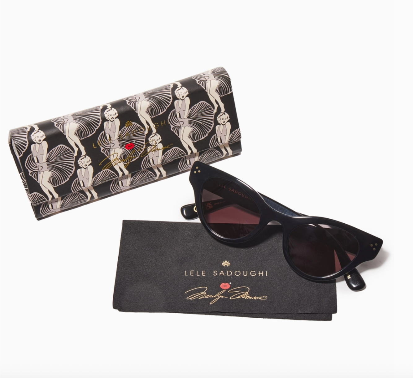 Black cat eye sunglasses with a patterned case and branded pouch on a white background